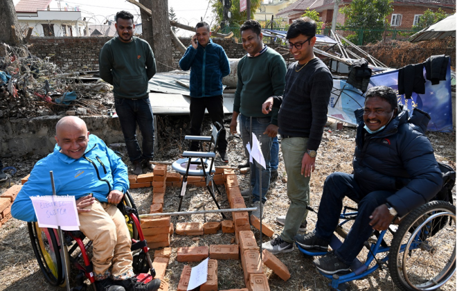 Deepak Khatri Chhetri and a group of other people around a pile of bricks well layed out.