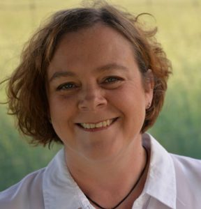 A photo of a smiling fair-haired woman with short hairstyle.